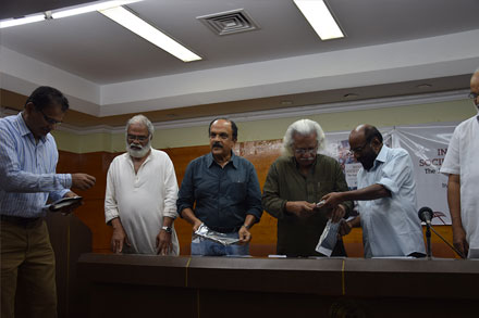 Adoor gives the book to M A Baby, Former Culture Minister.